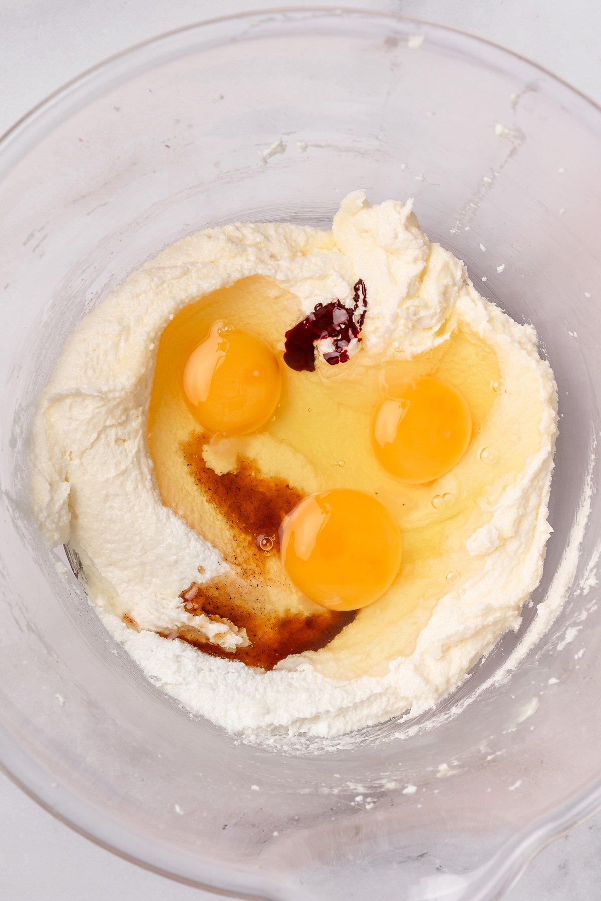 mixing butter and sugar with eggs and vanilla for red velvet cake