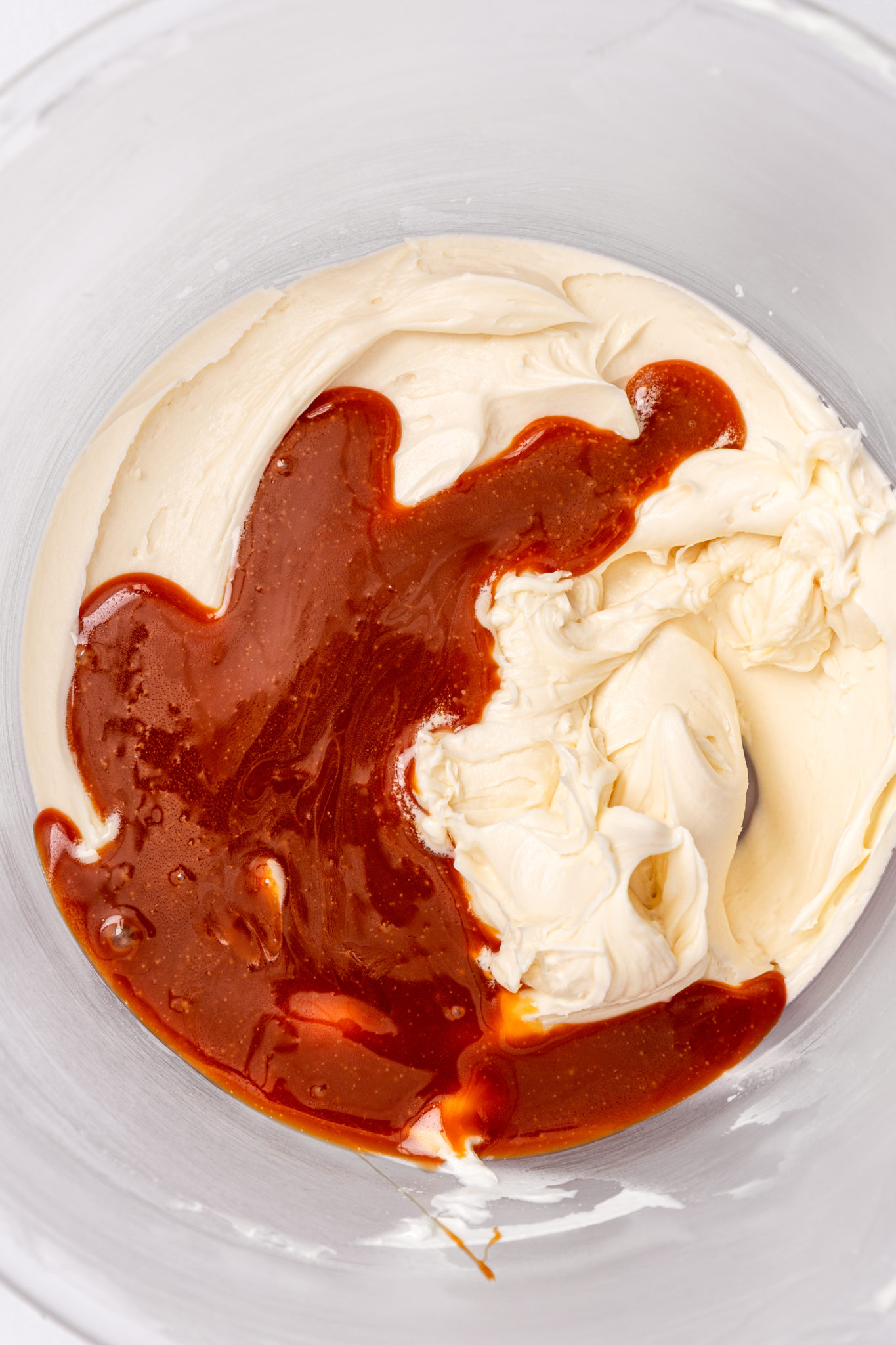 adding caramel sauce to American buttercream frosting