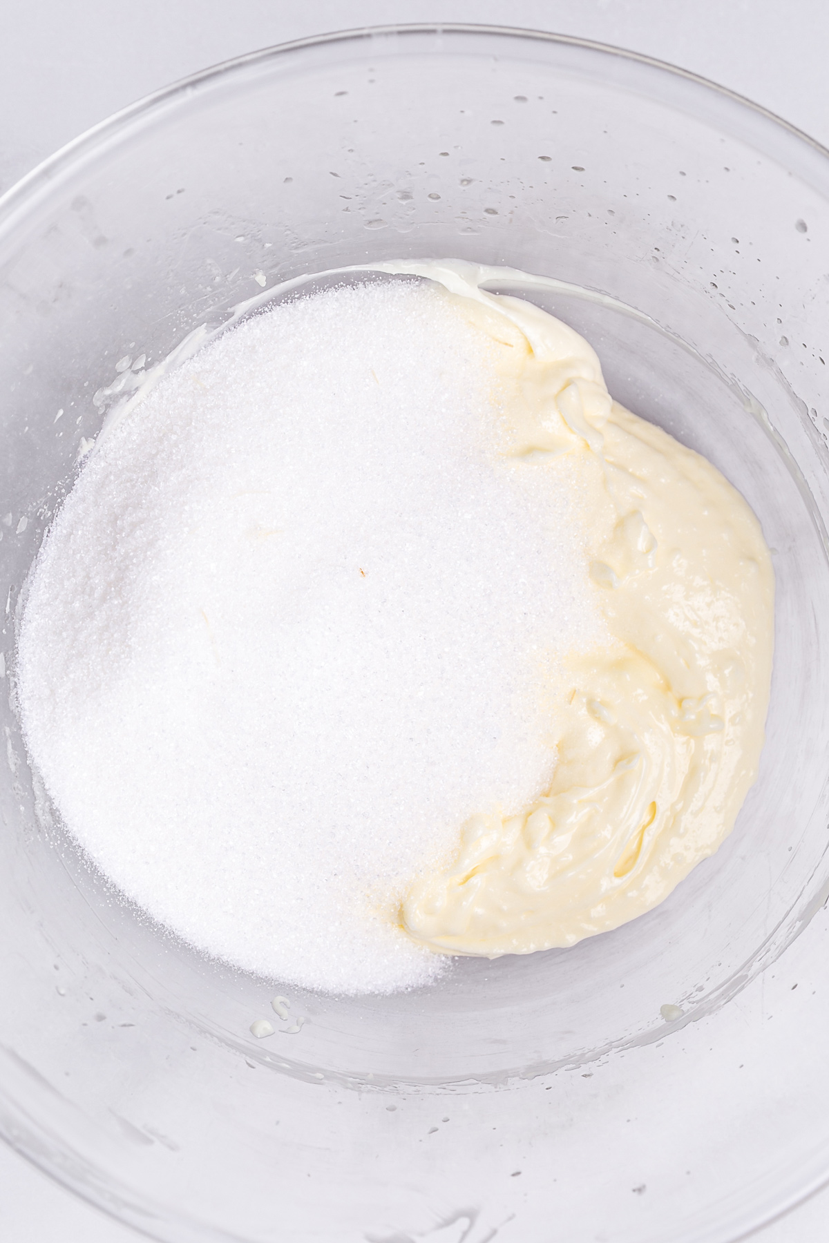 vanilla sheet cake batter with butter oil and sugar mixed in bowl
