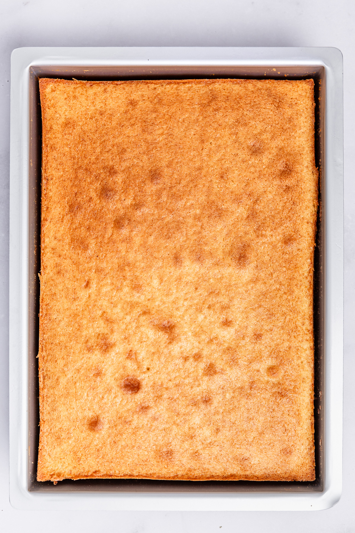 baked vanilla sheet cake in rectangular pan