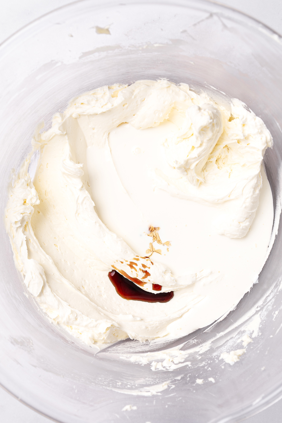 white chocolate buttercream frosting with cream and vanilla in bowl