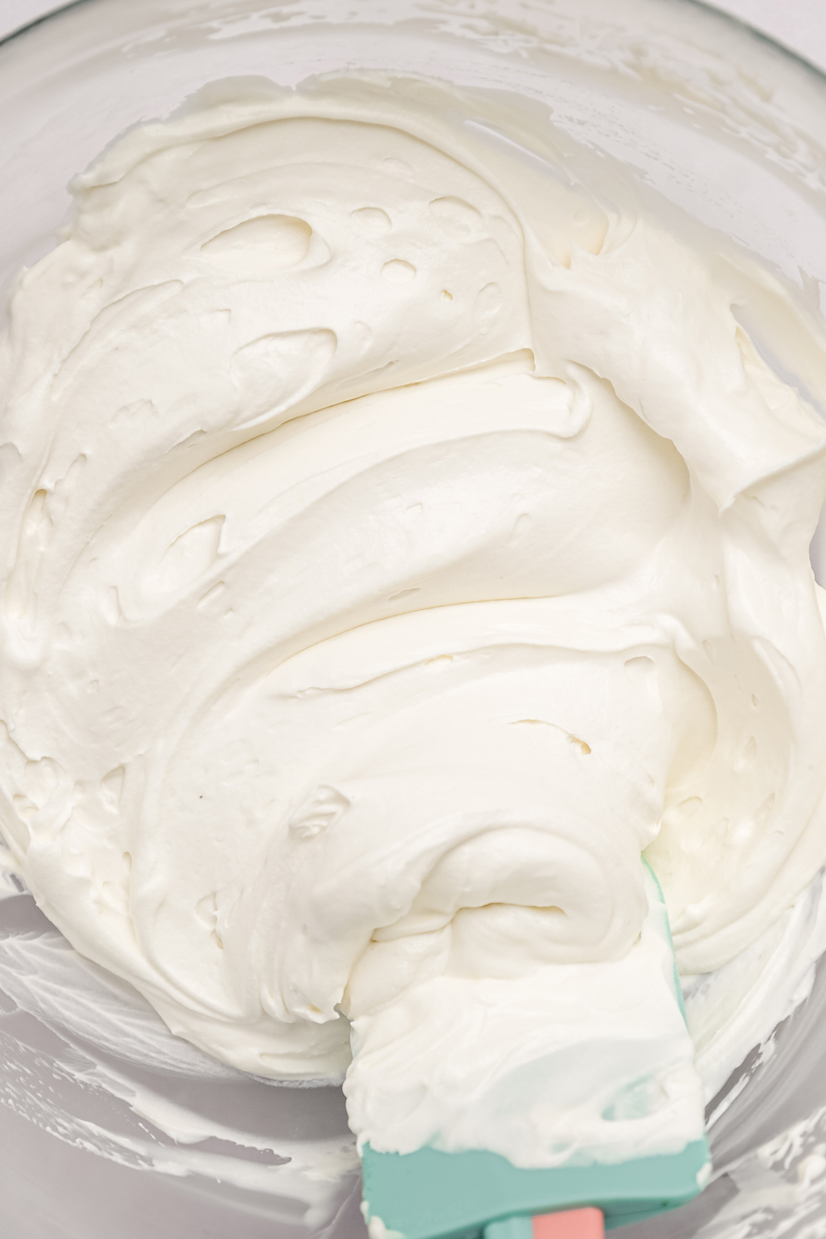whipped white chocolate ganache frosting in mixing bowl