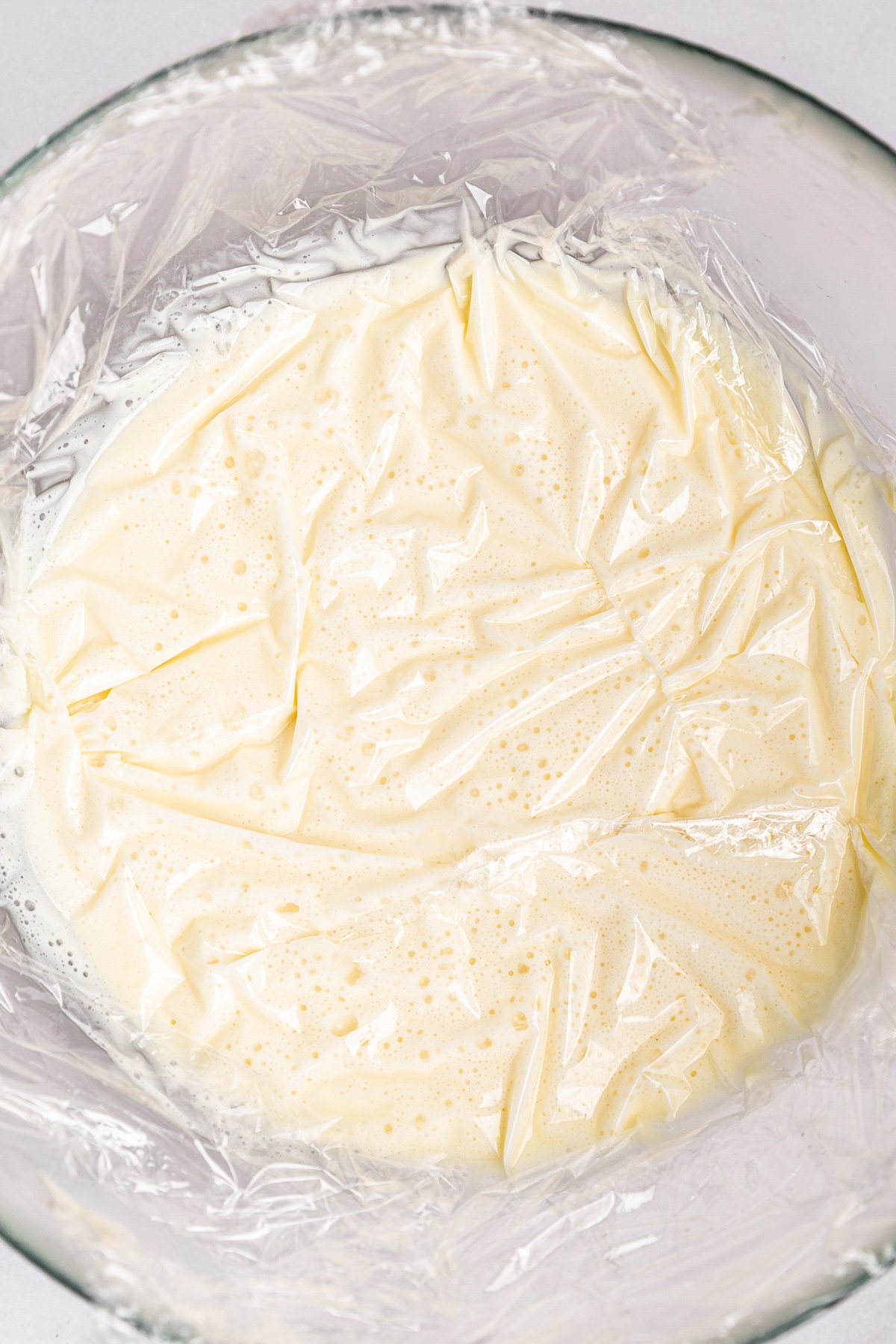 white chocolate ganache resting covered with plastic wrap