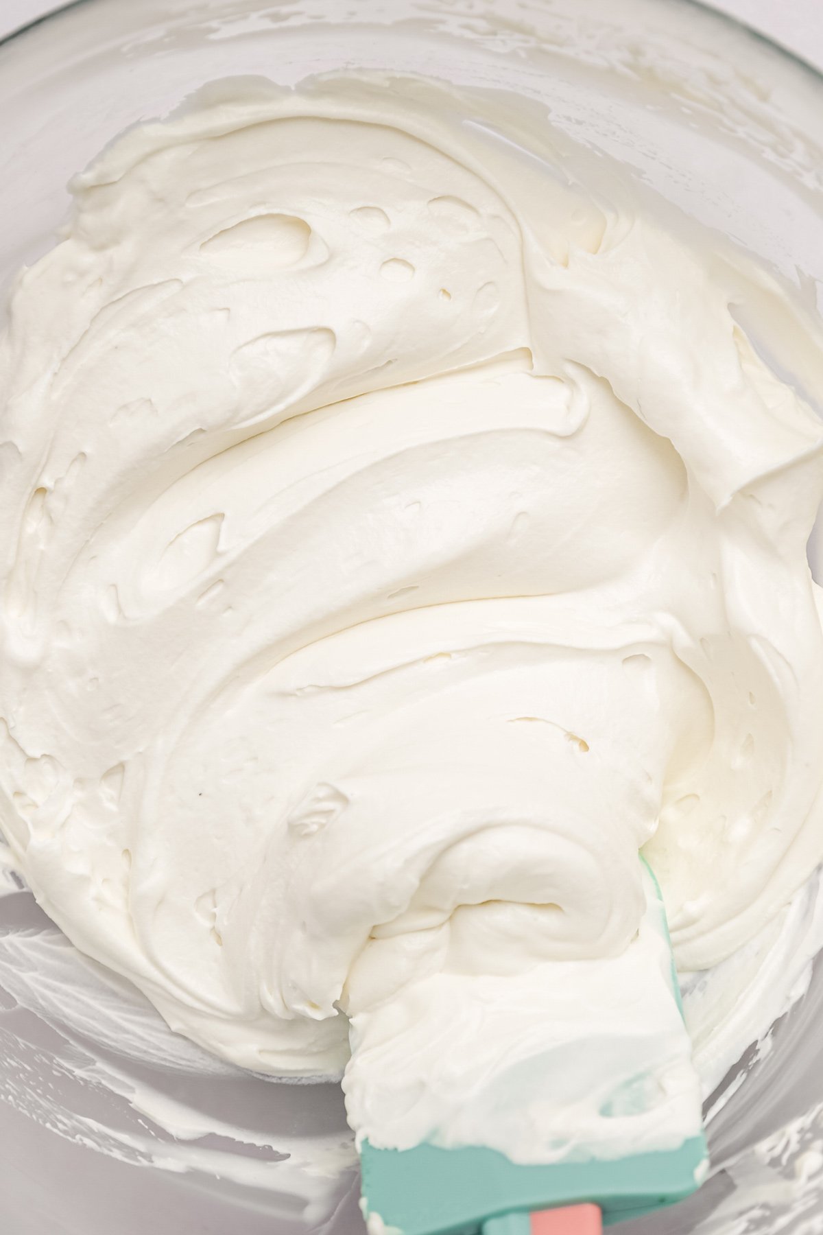 whipped white chocolate ganache frosting in mixing bowl
