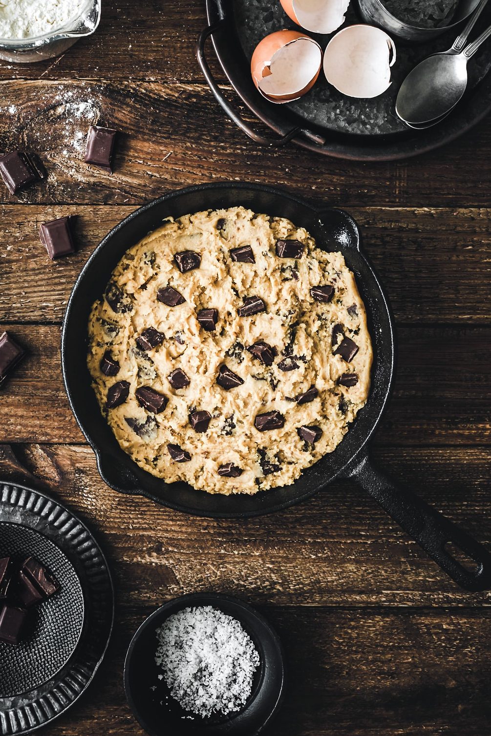 skillet chocolate chip cookie dough with chocolate chunks before baking