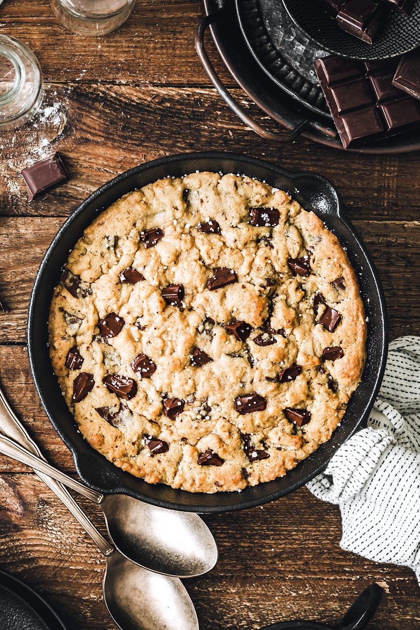 baked skillet chocolate chip cookie in cast iron pan on table