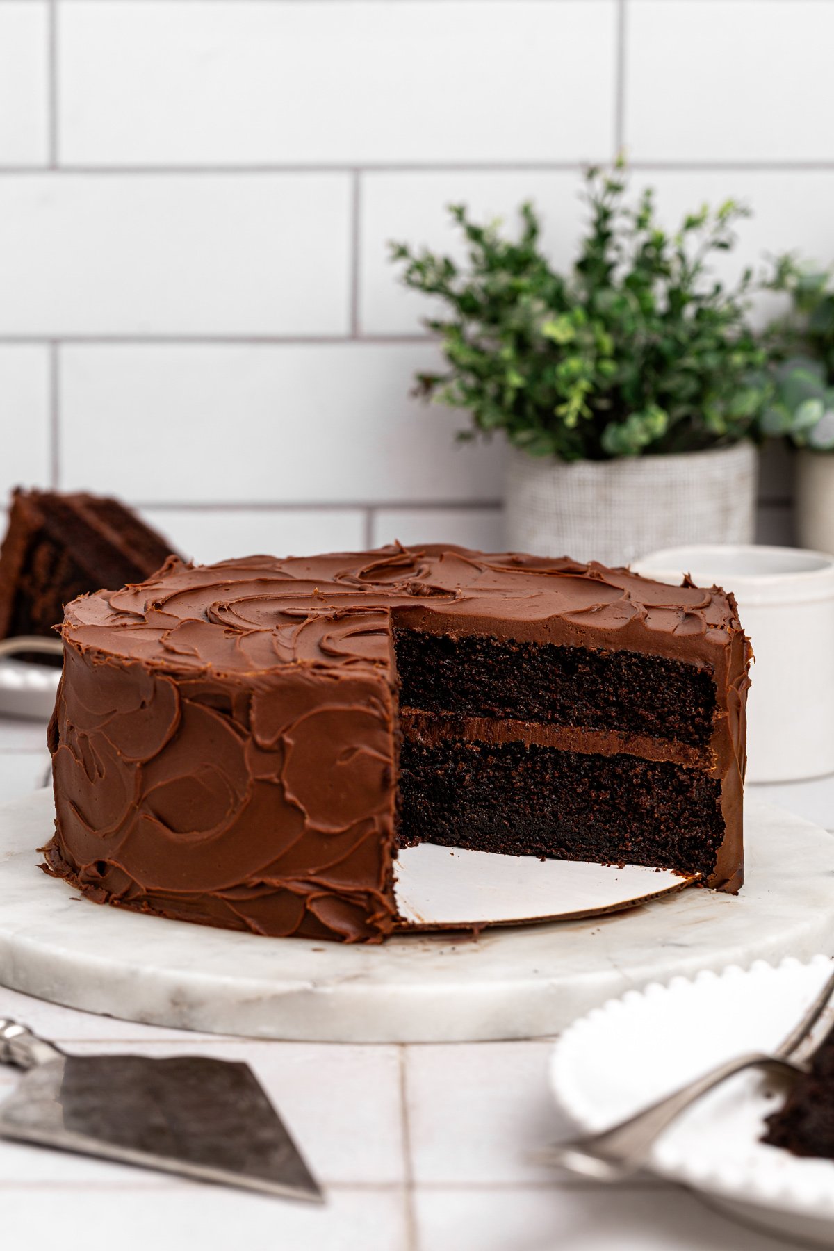 matilda cake with chocolate fudge frosting on a cake stand