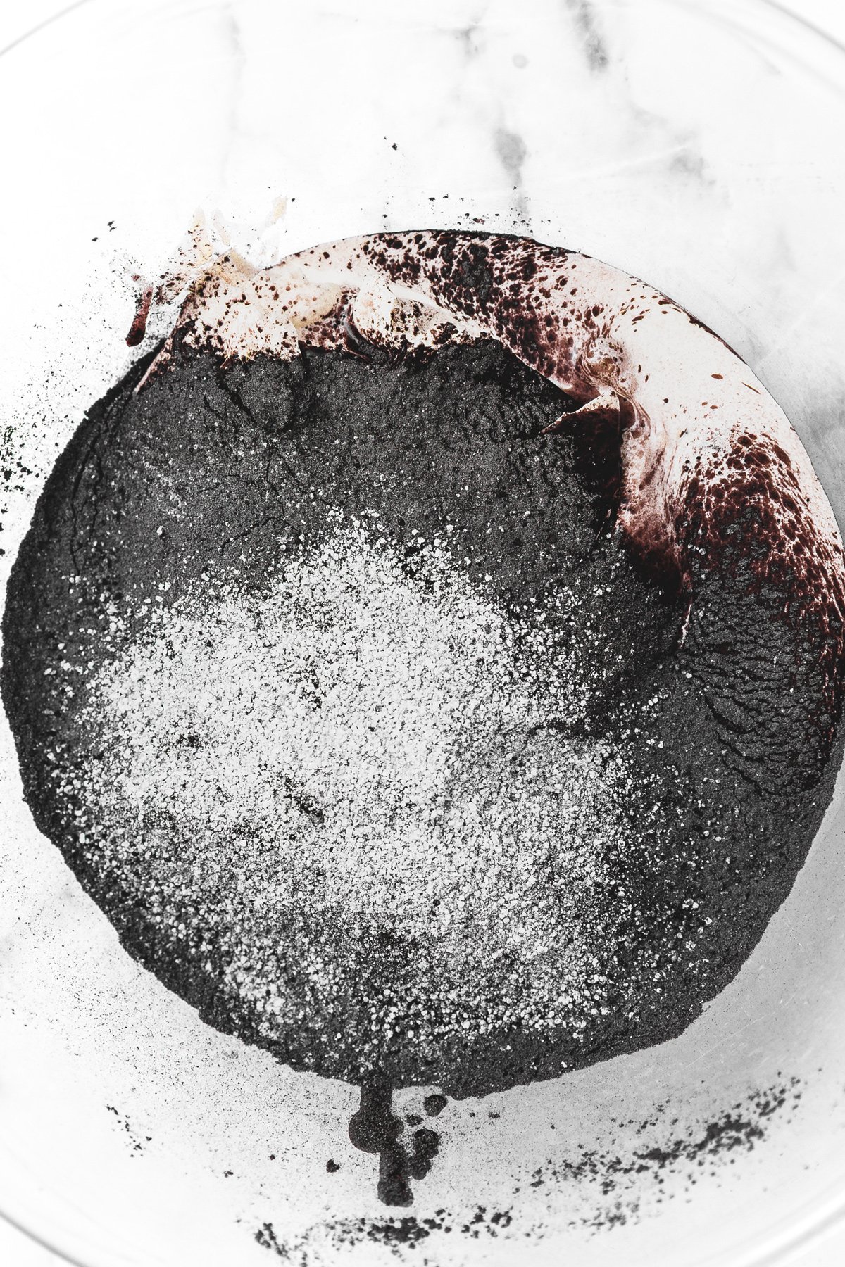 black cocoa frosting ingredients combined in a mixing bowl before whipping