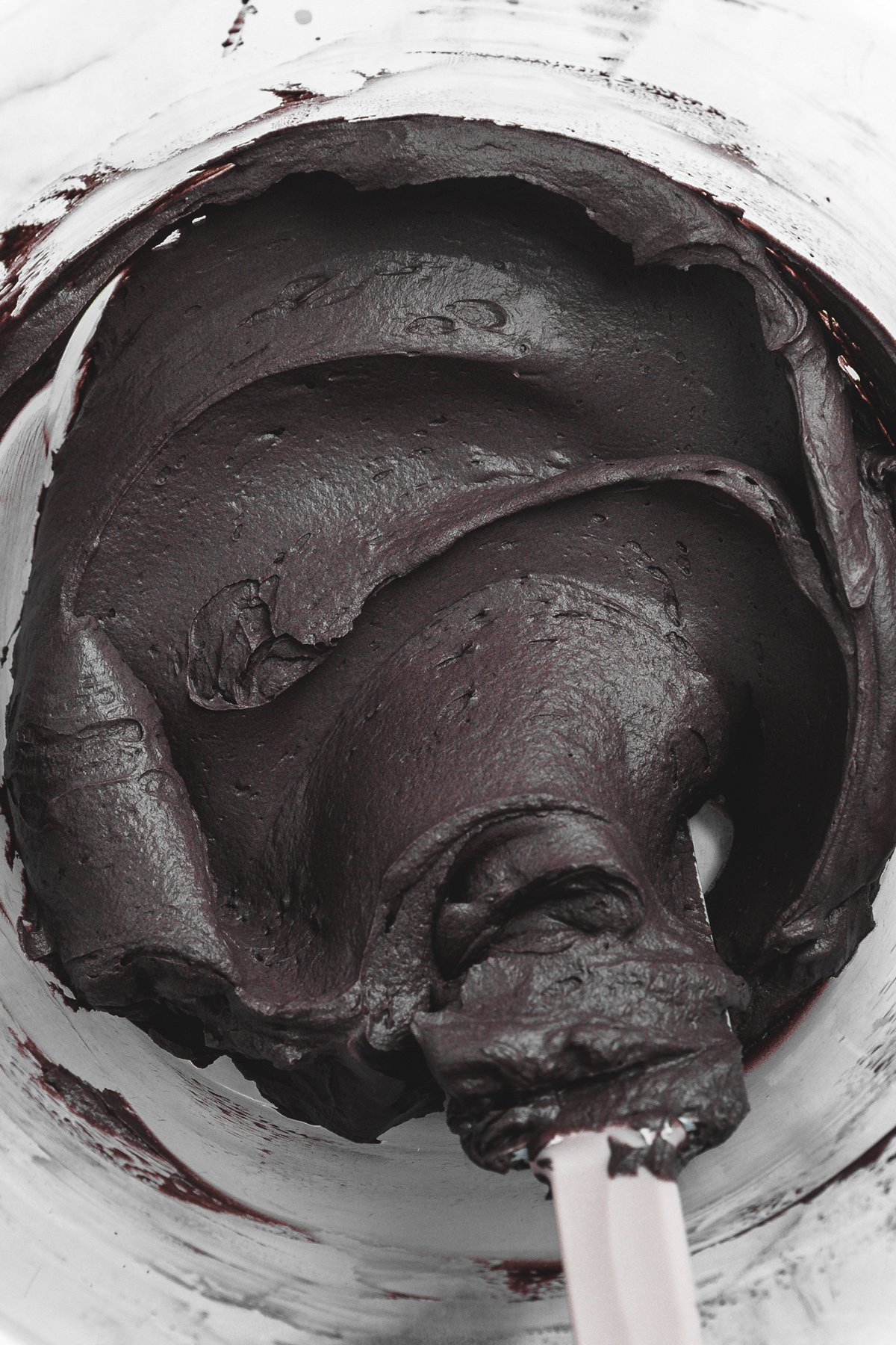 whipped black cocoa mascarpone frosting in a mixing bowl