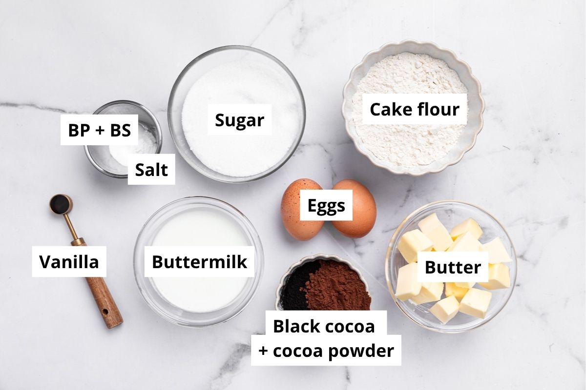 ingredients for black cocoa cupcakes including flour, black cocoa powder, sugar, butter and eggs