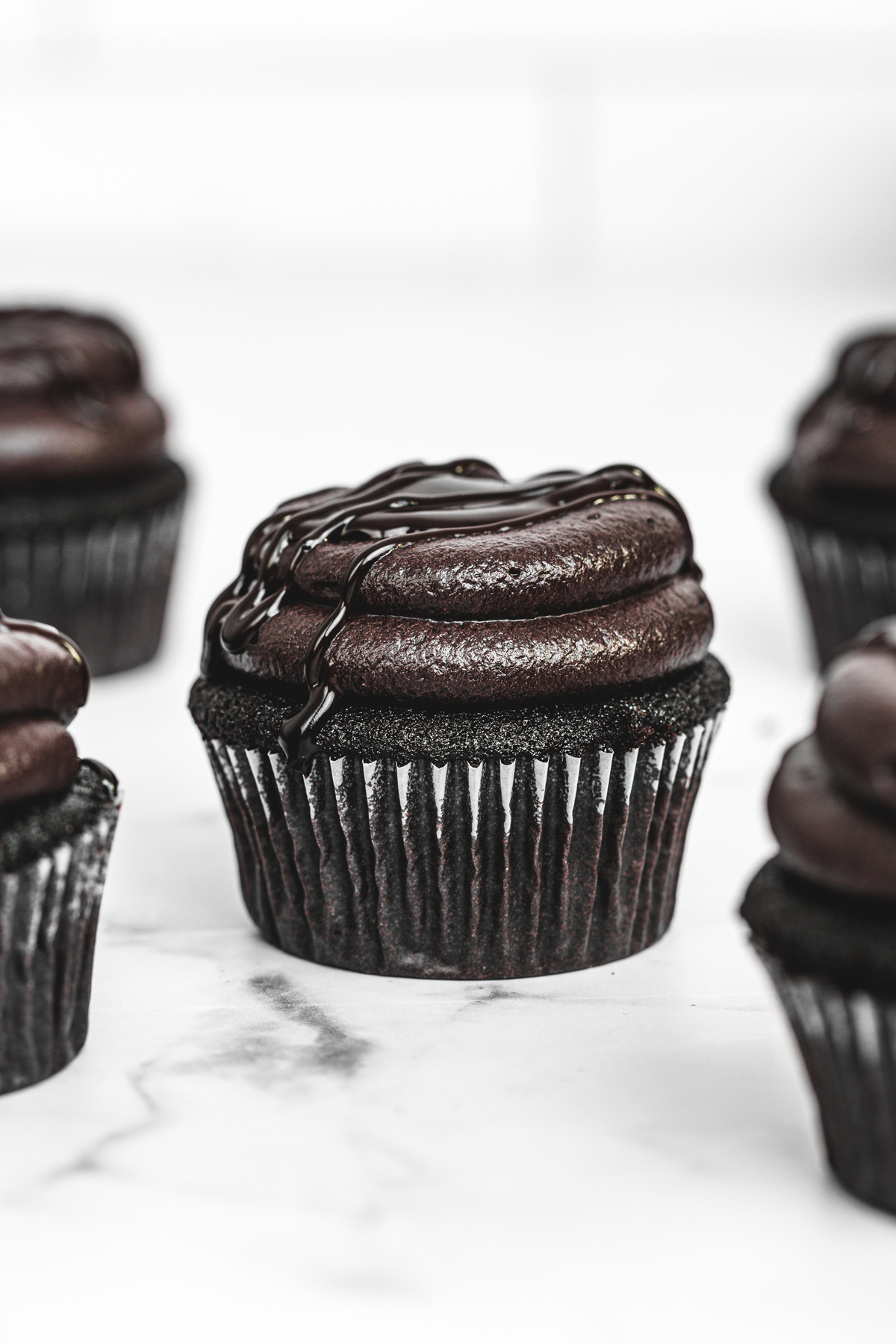 black cocoa cupcakes with black cocoa frosting on a table