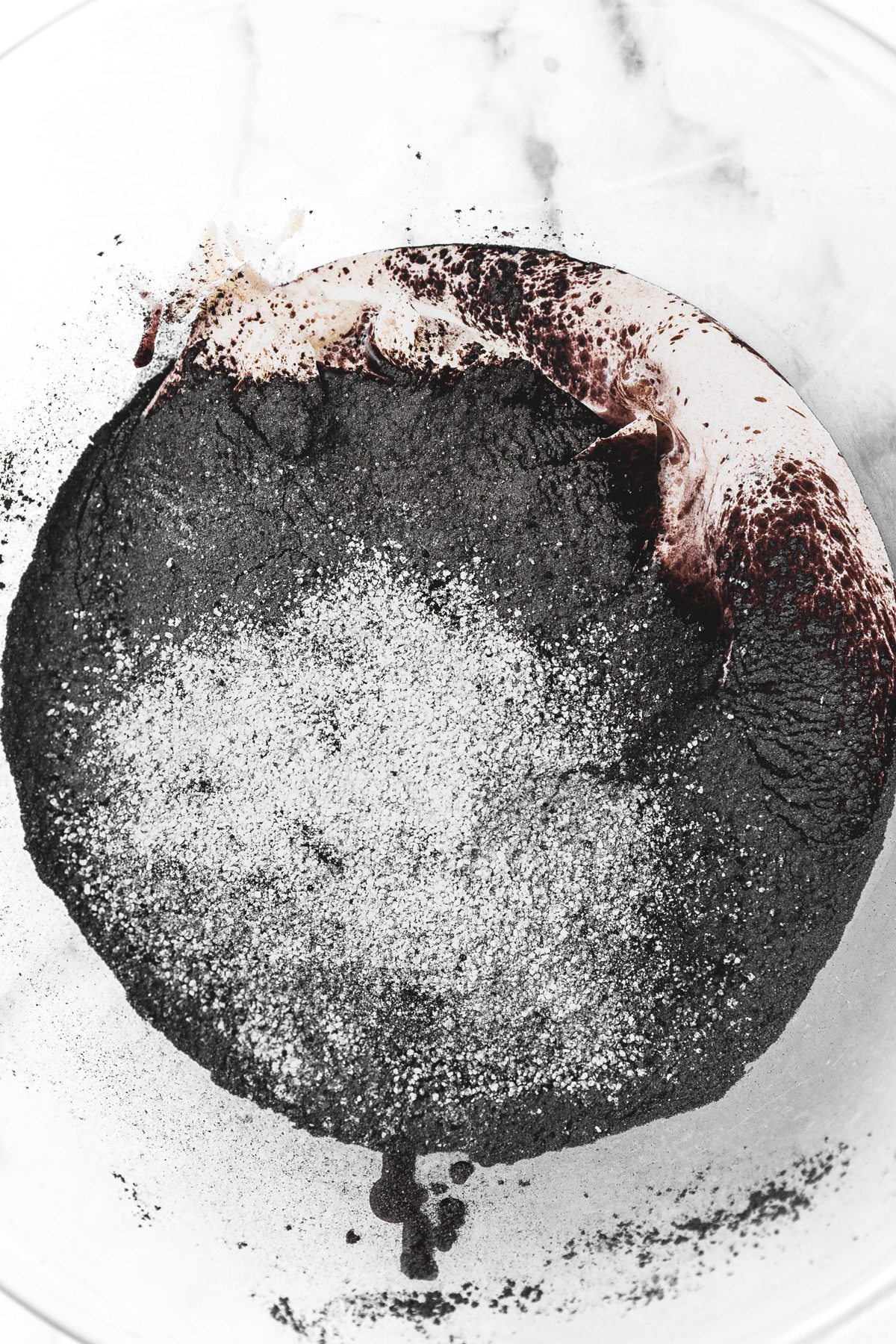 black cocoa frosting ingredients combined in a mixing bowl before whipping