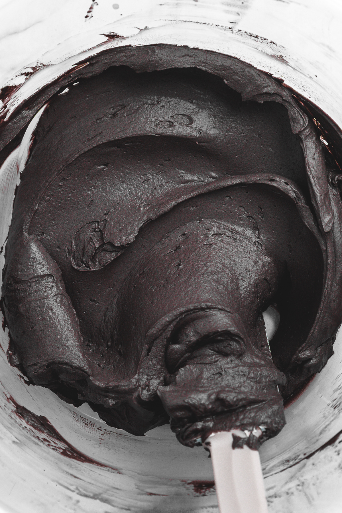 whipped black cocoa mascarpone frosting in a mixing bowl