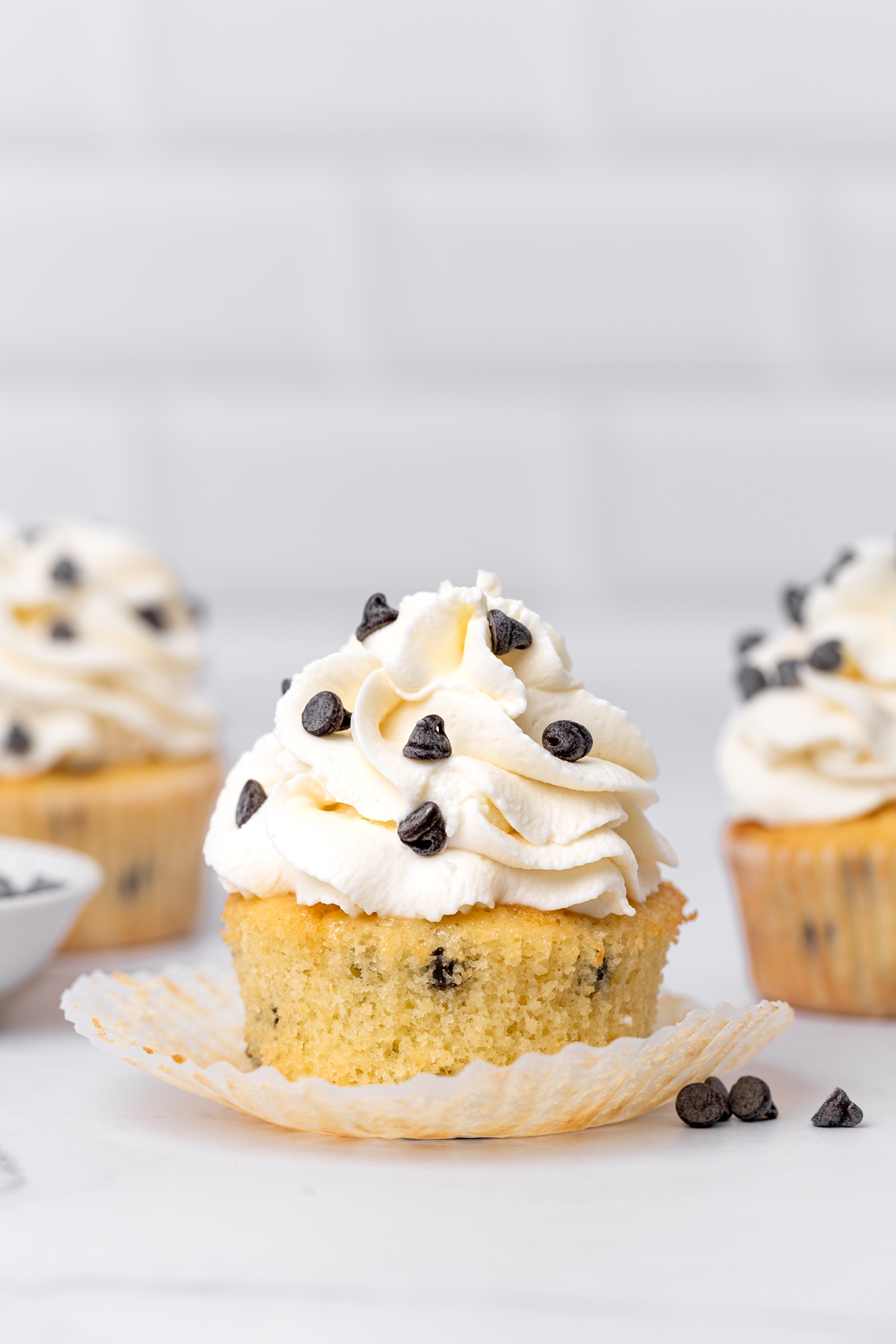 Chocolate chip cupcakes topped with creamy vanilla frosting