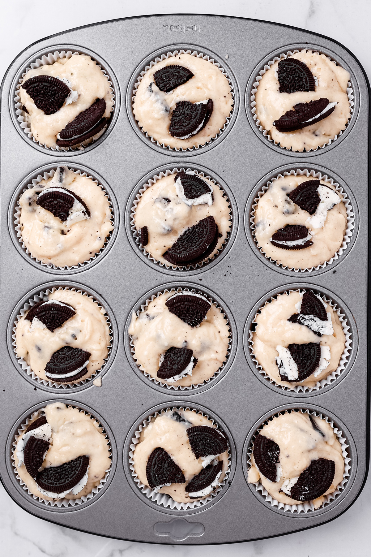 Oreo muffin batter in muffin liners before baking