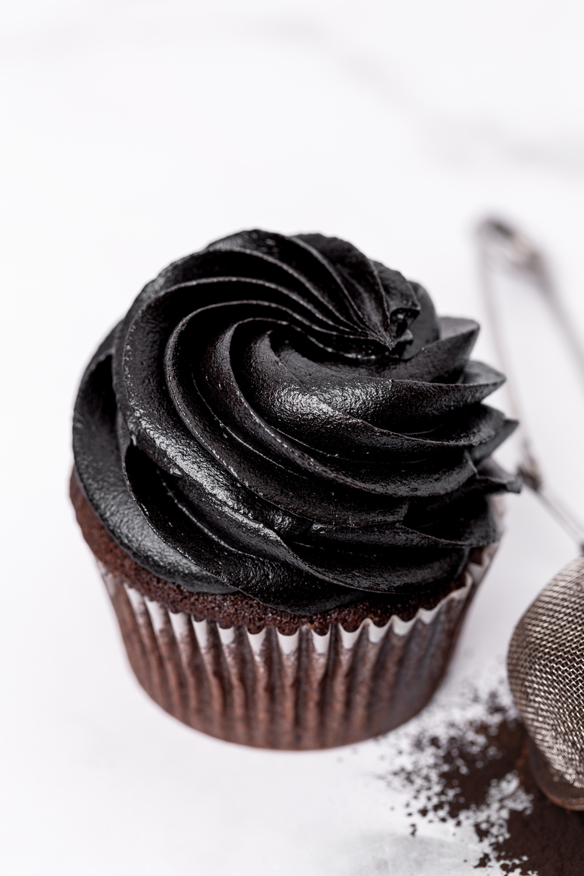 Chocolate cupcake topped with black buttercream frosting