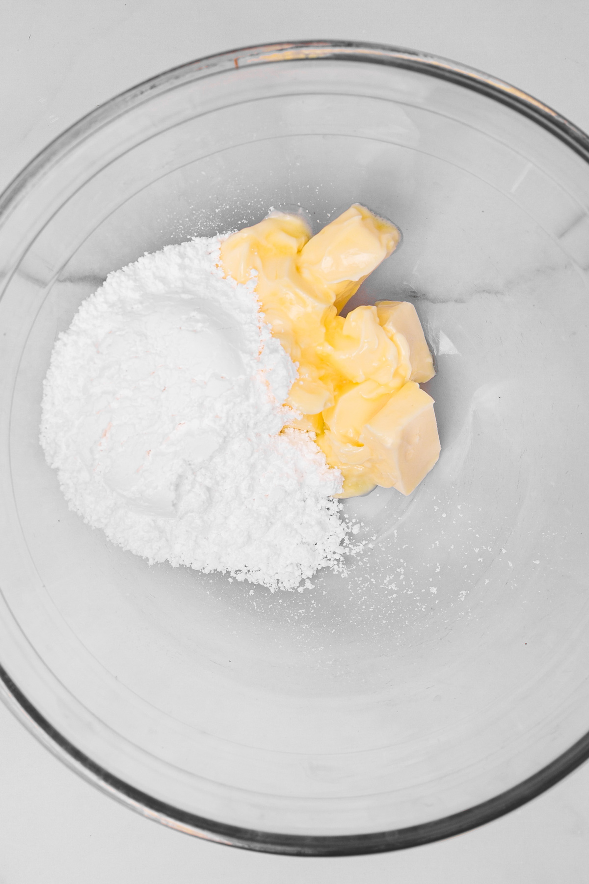 Butter and powdered sugar in mixing bowl