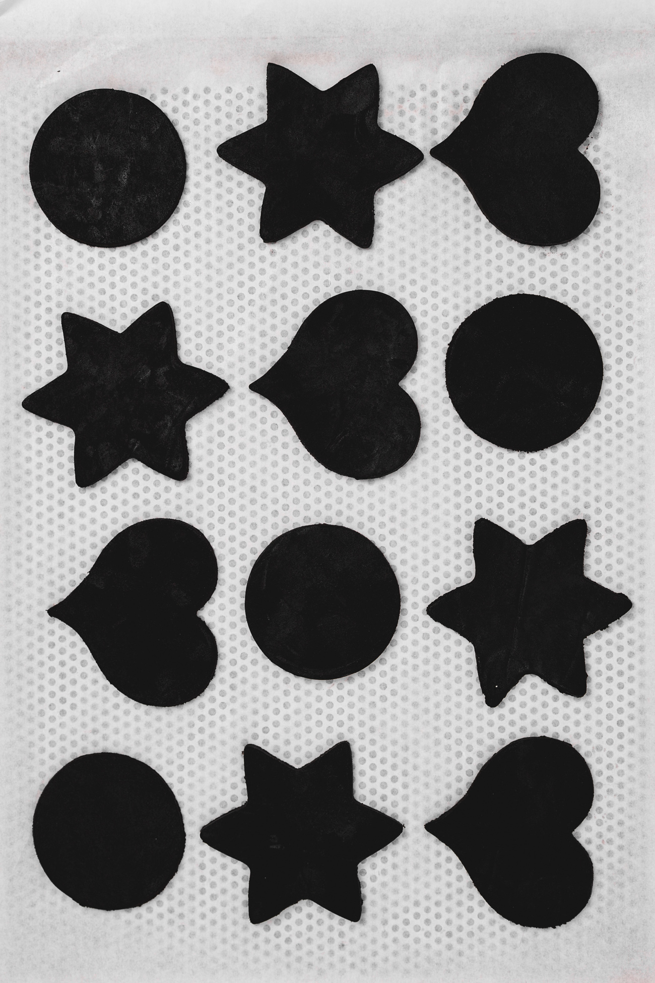 Black cocoa cut out cookie dough on baking sheet