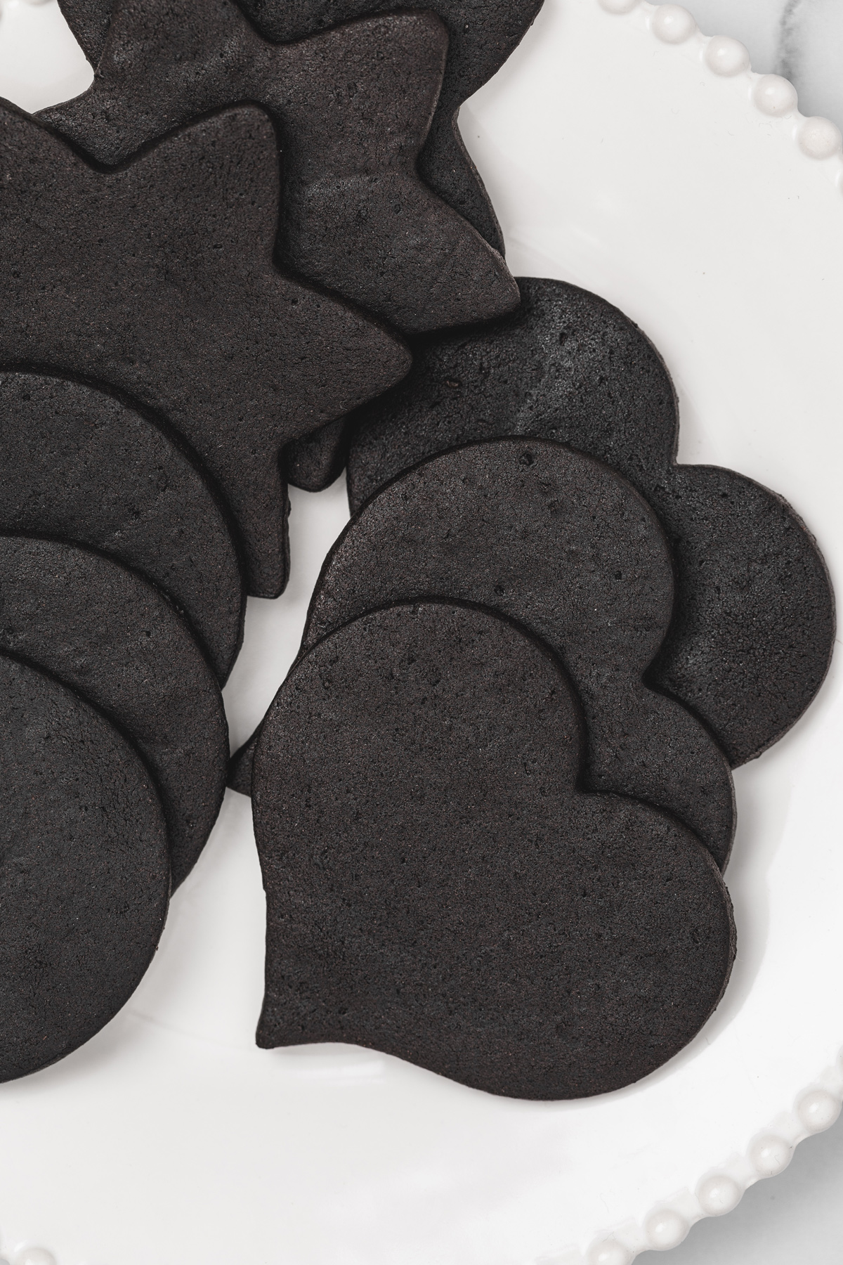 Black cocoa cut out cookies in heart, star and round shapes