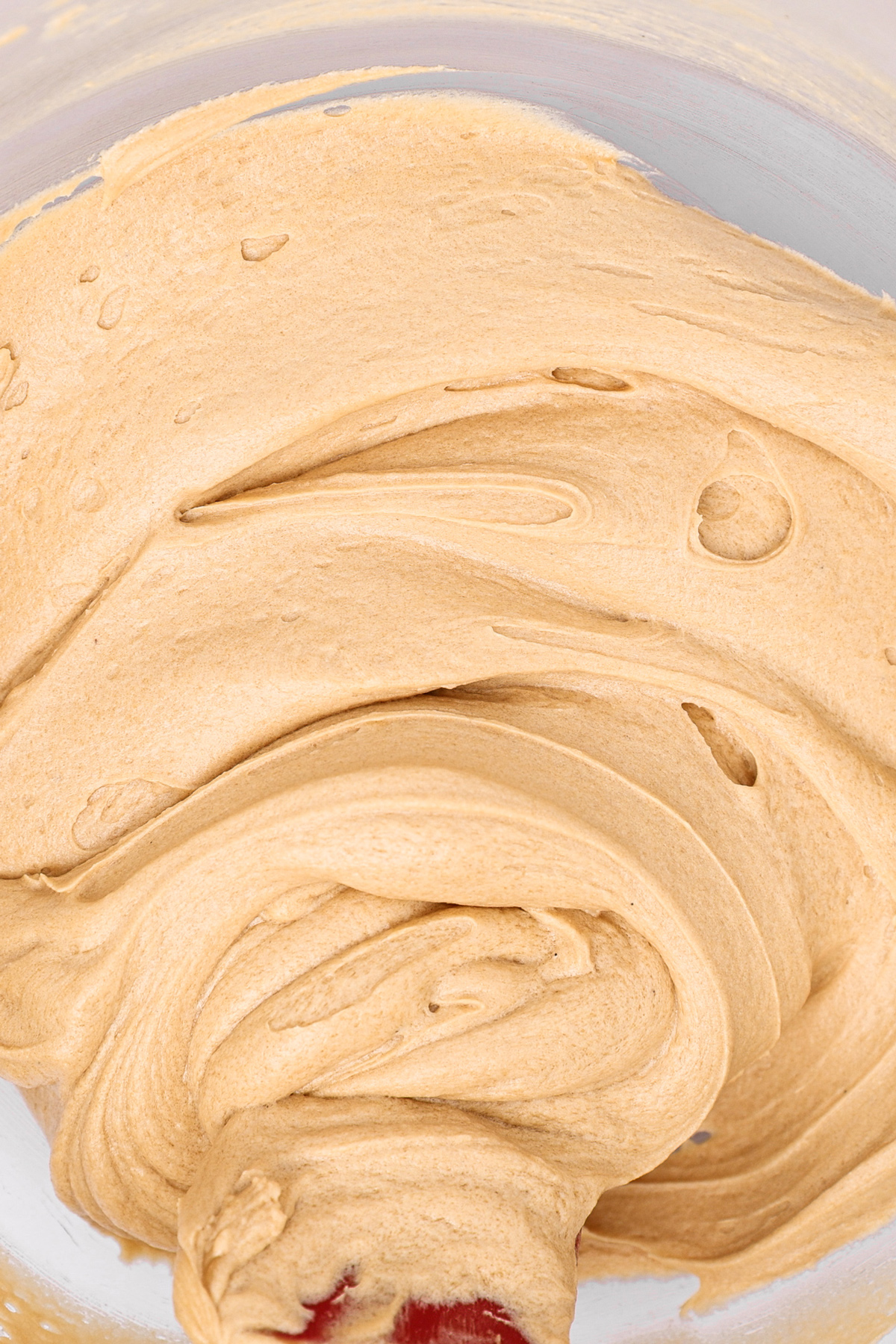 Smooth coffee buttercream frosting in a mixing bowl
