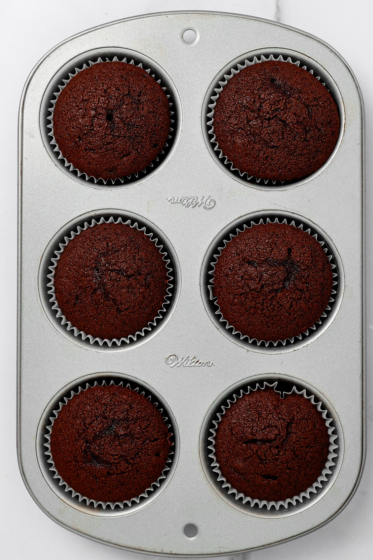 Baked chocolate coffee cupcakes in a muffin pan