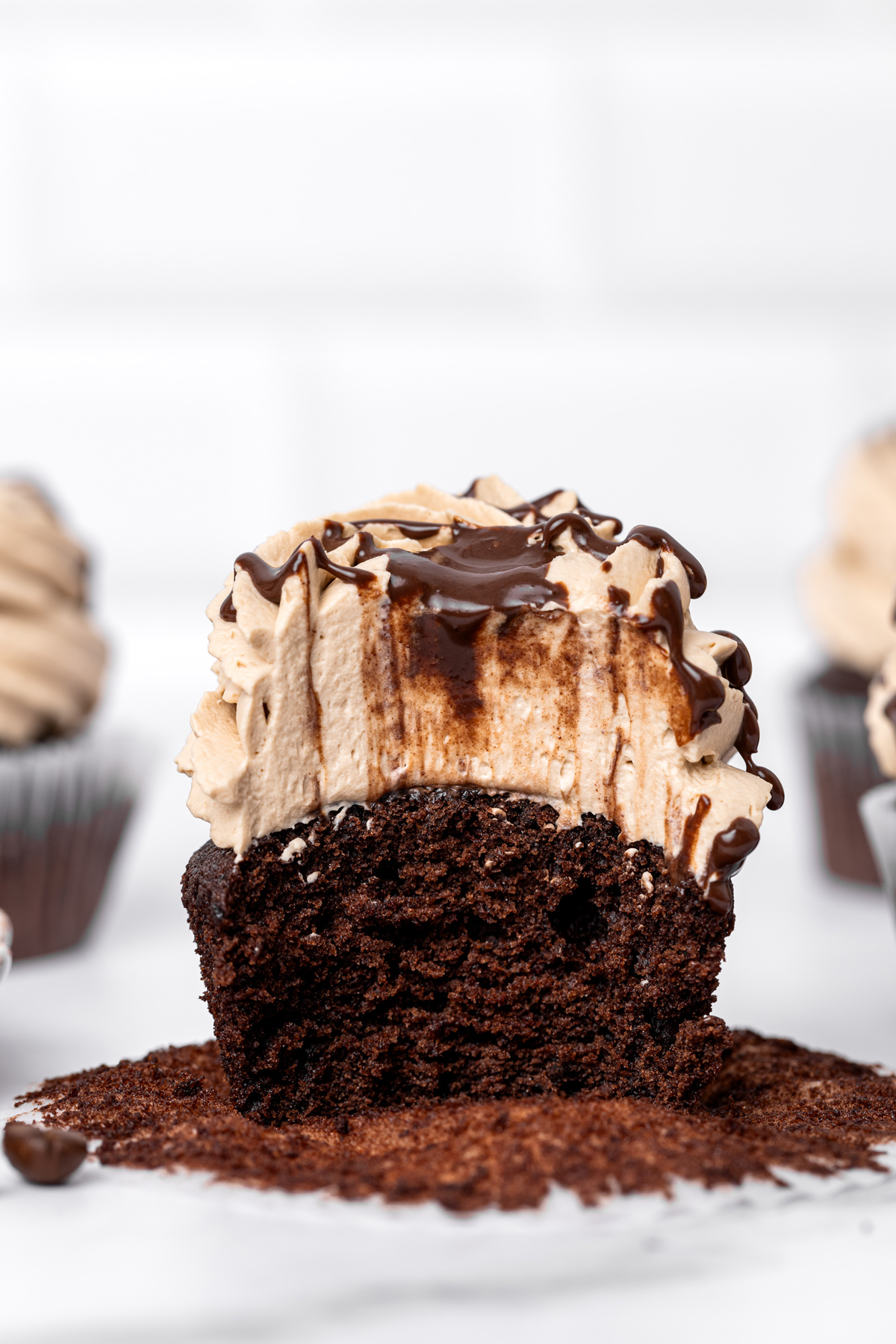 Mocha cupcake cut in half showing the moist chocolate crumb